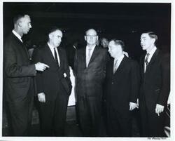 ["Black and white photograph print of Carl Albert posing with several other men while in Fresno, California. March 1962"]