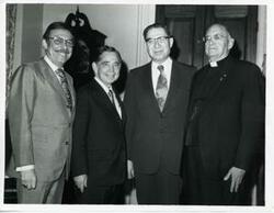 ["Black and white photograph print of Carl Albert posing with three unidentified men."]