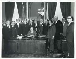 ["Black and white photograph print of Carl Albert, Hale Boggs, Peter Rodino, Thomas P. O'Neill, and others posing in Albert's office."]