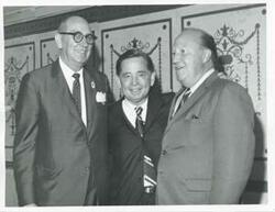 ["Black and white photograph print of Carl Albert posing with two unidentified men."]