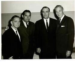 ["Black and white photograph print of Carl Albert posing with Fred Harris, Clem McSpadden, and A. S. Mike Monroney."]