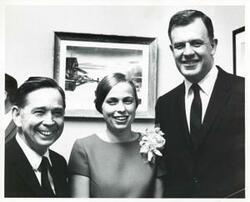["Black and white photograph print of Carl Albert standing with two unidentified people."]