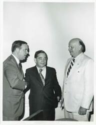 ["Black and white photograph print of Carl Albert and Robert L. F. Sikes. They are holding two plaques."]