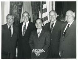 ["Black and white photograph print of Carl Albert, Gerald R. Ford and three other men posing for a picture. John Brademas is present in #3002."]