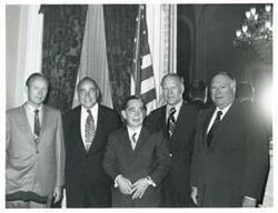 ["Black and white photograph print of Carl Albert, Gerald R. Ford and three other men posing for a picture. John Brademas is present in #3002."]