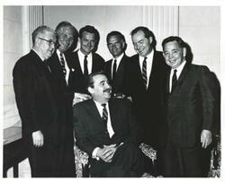 ["Black and white photograph print of Democratic members of Oklahoma delegation with an unidentified man. Standing is Tom Steed, A. S. Mike Monroney, Jed Johnson, Jr., John Jarman, Ed Edmondson and Carl Albert."]
