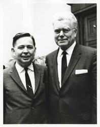 ["Black and white photograph print of Carl Albert posing with an unidentified man."]