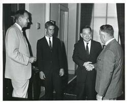 ["Black and white photograph print of Carl Albert with Congressman Van Deerlin and two unidentified men."]