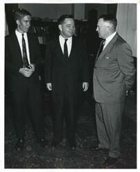 ["Black and white photograph print of Carl Albert with unidentified men."]