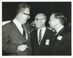 ["Black and white photograph print of Carl Albert with Samuel N. Friedel and another man at a dinner honoring Friedel. September 28-29, 1965"]