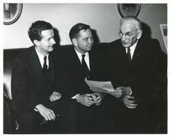 ["Black and white photograph print of Jed Johnson, Jr., Carl Albert, and John W. McCormack seated on a couch"]