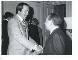 ["Black and white photograph print of Carl Albert shaking hands with Johnny Bench, Cincinnati Reds baseball player. December 1976"]