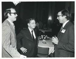 ["Black and white photograph print of Carl Albert speaking with two unidentified men at the reception for freshman members of the 94th Congress. December 1, 1975"]
