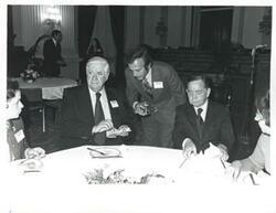 ["Black and white photograph print of Carl Albert and Thomas P. O'Neill seated at a dinner table at the reception for freshman members of the 94th Congress. December 1, 1975"]