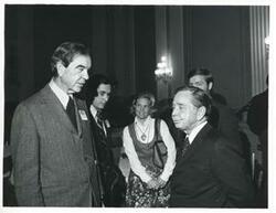 ["Black and white photograph print of Carl Albert speaking with George Mahon and others at a reception for freshman members of the 94th Congress. December 1, 1975"]