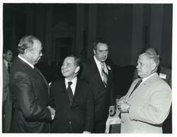["Black and white photograph print of Carl Albert, Olin Teague and others at a reception for freshman members of the 94th Congress. December 1, 1975"]