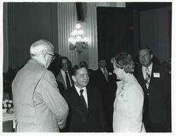 ["Black and white photograph print of Carl Albert with unidentified people at a reception for freshman members of the 94th Congress. December 1, 1975"]