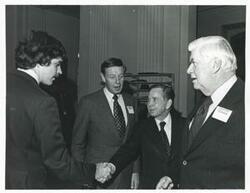 ["Black and white photograph print of Carl Albert and Thomas P. O'Neill speaking with two unidentified people at a reception for freshman members of the 94th Congress. December 1, 1975"]