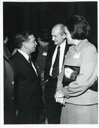 ["Black and white photograph print of Carl Albert speaking with two unidentified people at a reception for freshman members of the 94th Congress. December 1, 1975"]