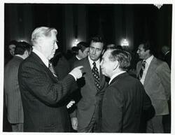 ["Black and white photograph print of Carl Albert with several others at a reception of freshman members of the 94th Congress. December 1, 1975"]