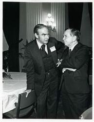 ["Black and white photograph print of Carl Albert speaking with James C. Wright at a reception for freshman members of the 94th Congress. December 1, 1975"]