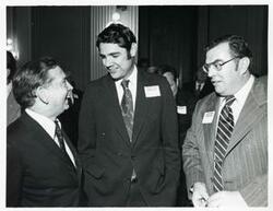 ["Black and white photograph print of Carl Albert talking with two unidentified men at the reception for freshman members of the 94th Congress. December 1, 1975"]