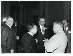 ["Black and white photograph print of Carl Albert speaking with Olin Teague and others at a reception for freshman members of the 94th Congress. December 1, 1975"]