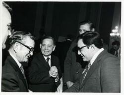 ["Black and white photograph print of Carl Albert speaking with several unidentified men at a reception for freshman members of the 94th Congress. December 1, 1975"]