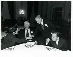 ["Black and white photograph print of Carl Albert, Thomas P. O'Neill, and others at a reception for freshman members of the 94th Congress. December 1, 1975"]