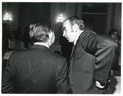 ["Black and white photograph print of Carl Albert speaking with James C. Wright at a reception honoring freshman members of the 94th Congress. December 1, 1975"]