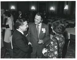 ["Black and white photograph print of Carl Albert speaking with two unidentified people at a reception honoring freshman members of the 94th Congress. December 1, 1975"]