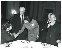 ["Black and white photograph print of Carl Albert, Thomas P. O'Neill, and others at a reception honoring freshman members of the 94th Congress. December 1, 1975"]