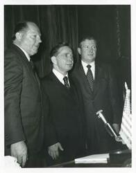 ["Black and white photograph print of Carl Albert with unidentified men."]