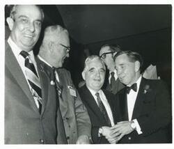 ["Black and white photograph print of Carl Albert with unidentified people."]