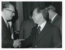["Black and white photograph print of Carl Albert with unidentified people."]