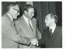 ["Black and white photograph print of Carl Albert with unidentified people."]