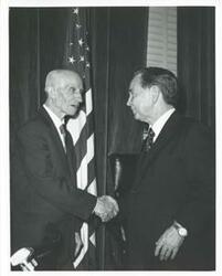 ["Black and white photograph print of Carl Albert shaking hands with James Byrnes."]