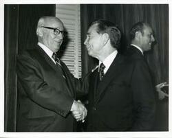 ["Black and white photograph print of Carl Albert shaking hands with Melvin Price"]