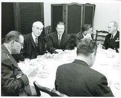 ["Black and white photograph print of John W. McCormack, Robert S. McNamara, Carl Albert, and others seated at a dinner table in the Joe Martin Room. March 30, 1967"]