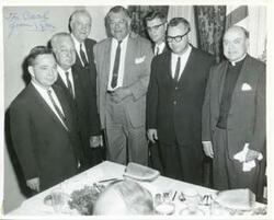 ["Black and white photograph print of Carl Albert with unidentified men at a steak dinner. August 3, 1964"]