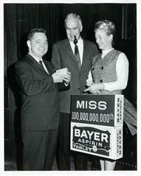 ["Black and white photograph print of Carl Albert standing with two unidentified men."]