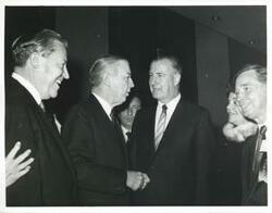 ["Black and white photograph print of Carl Albert standing with Mr. and Mrs. Spiro Agnew and others."]