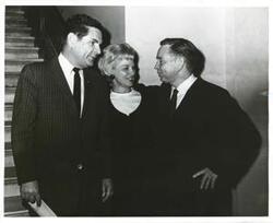 ["Black and white photograph print of Carl Albert speaking with two unidentified people."]