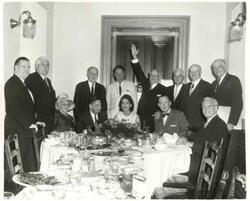 ["Black and white photograph print of Carl Albert, Hale Boggs, Robert L. F. Sikes, and others seated at a dinner table."]