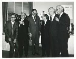 ["Black and white photograph print of Carl Albert with unidentified people."]