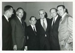 ["Black and white photograph print of Carl Albert with unidentified people."]
