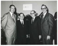 ["Black and white photograph print of Carl Albert with unidentified people."]