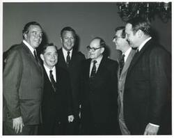 ["Black and white photograph print of Carl Albert with unidentified people."]