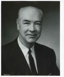 ["Black and white photograph print of studio portrait of an unidentified man."]