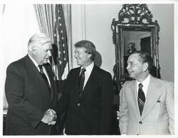 ["Black and white photograph print of Jimmy Carter shaking hands with Thomas P. O'Neill as Carl Albert looks on. Also O'Neill shaking hands with Albert while Carter looks on. June 24, 1976"]